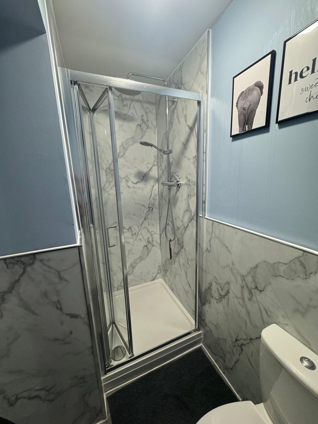 Bathroom in Exeter after renovation — new marble-effect walk-in shower