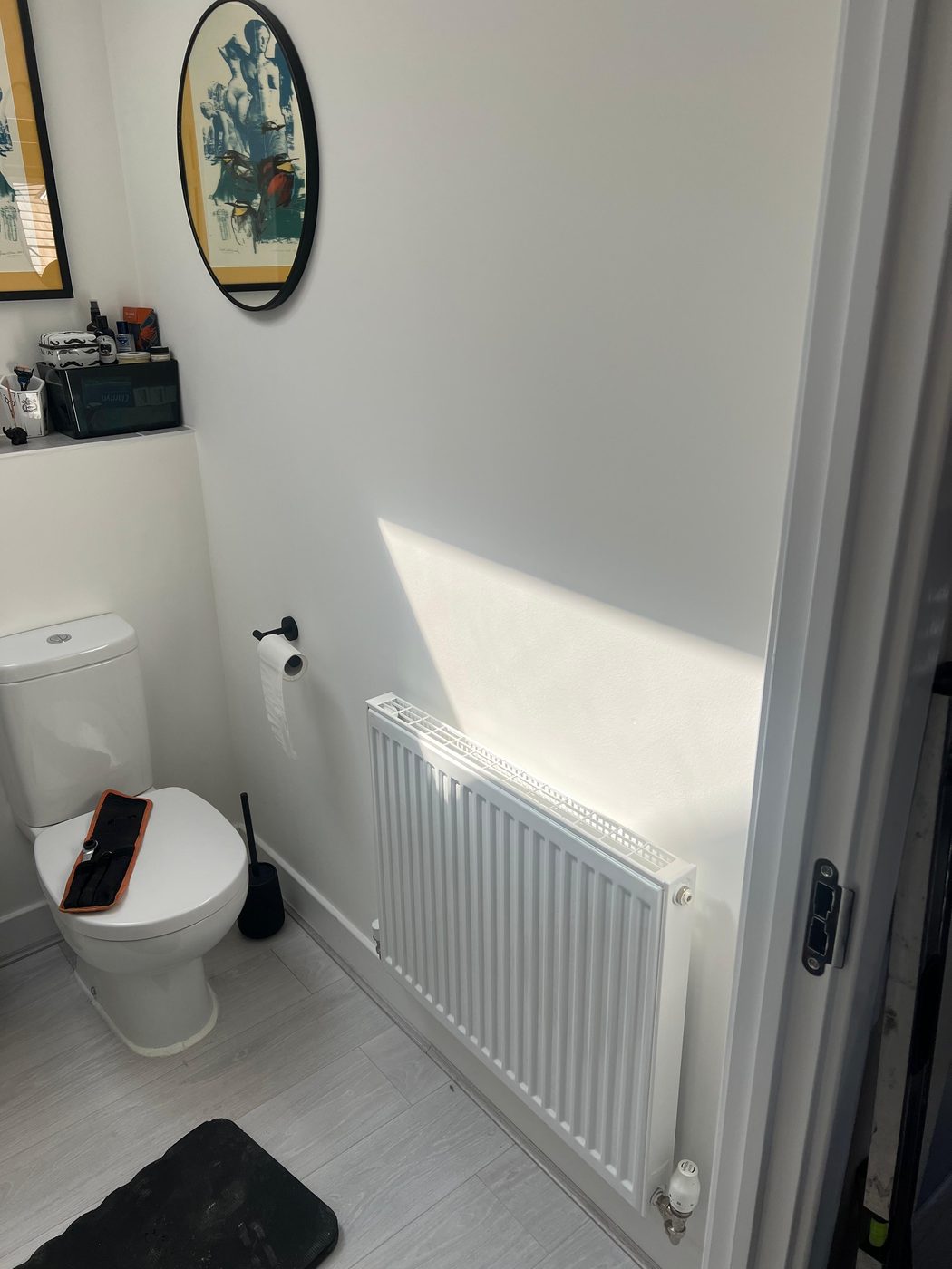 Cloakroom in Exeter before — old white radiator