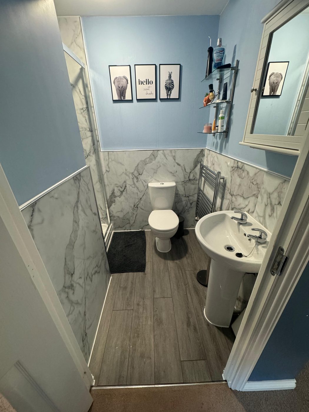 Finished marble-effect bathroom with new toilet and basin in Exeter