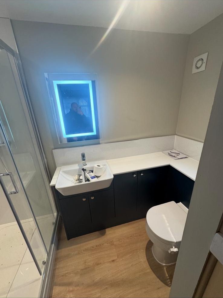 Modern bathroom in Exeter with walk-in shower and black vanity unit