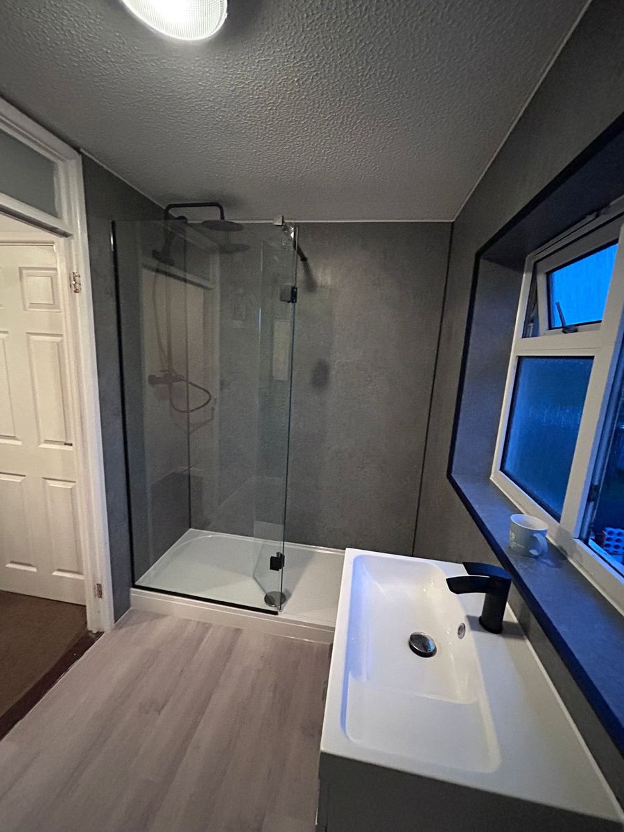 Bathroom after — grey walk-in shower and vanity
