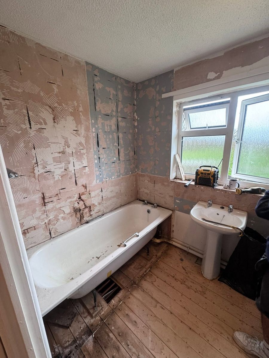 Bathroom before — stripped back to the floorboards