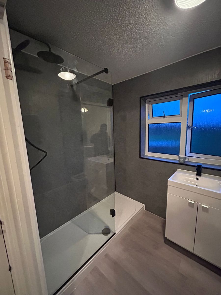 Grey walk-in shower with black fittings