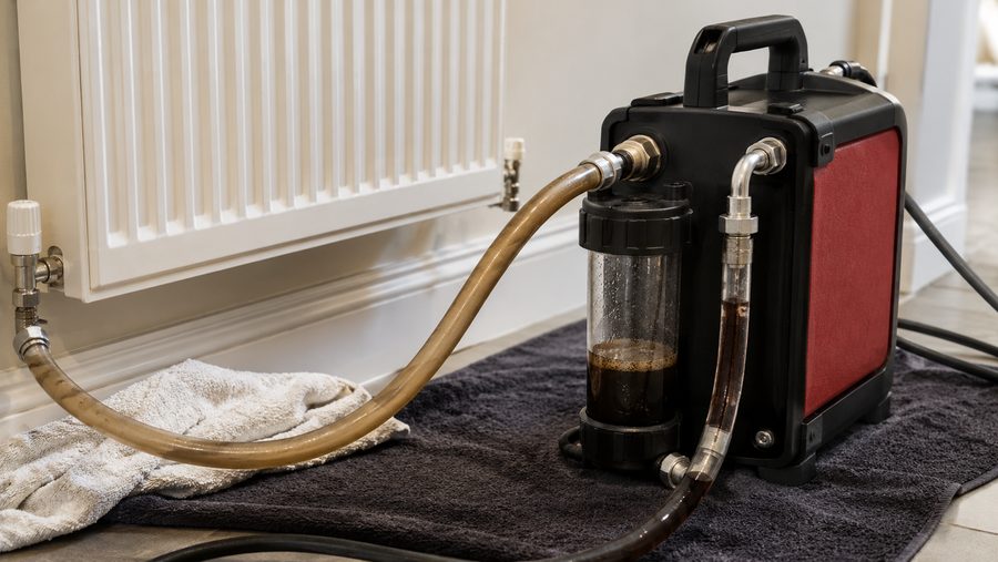 Power flushing machine cleaning a heating system in Exeter